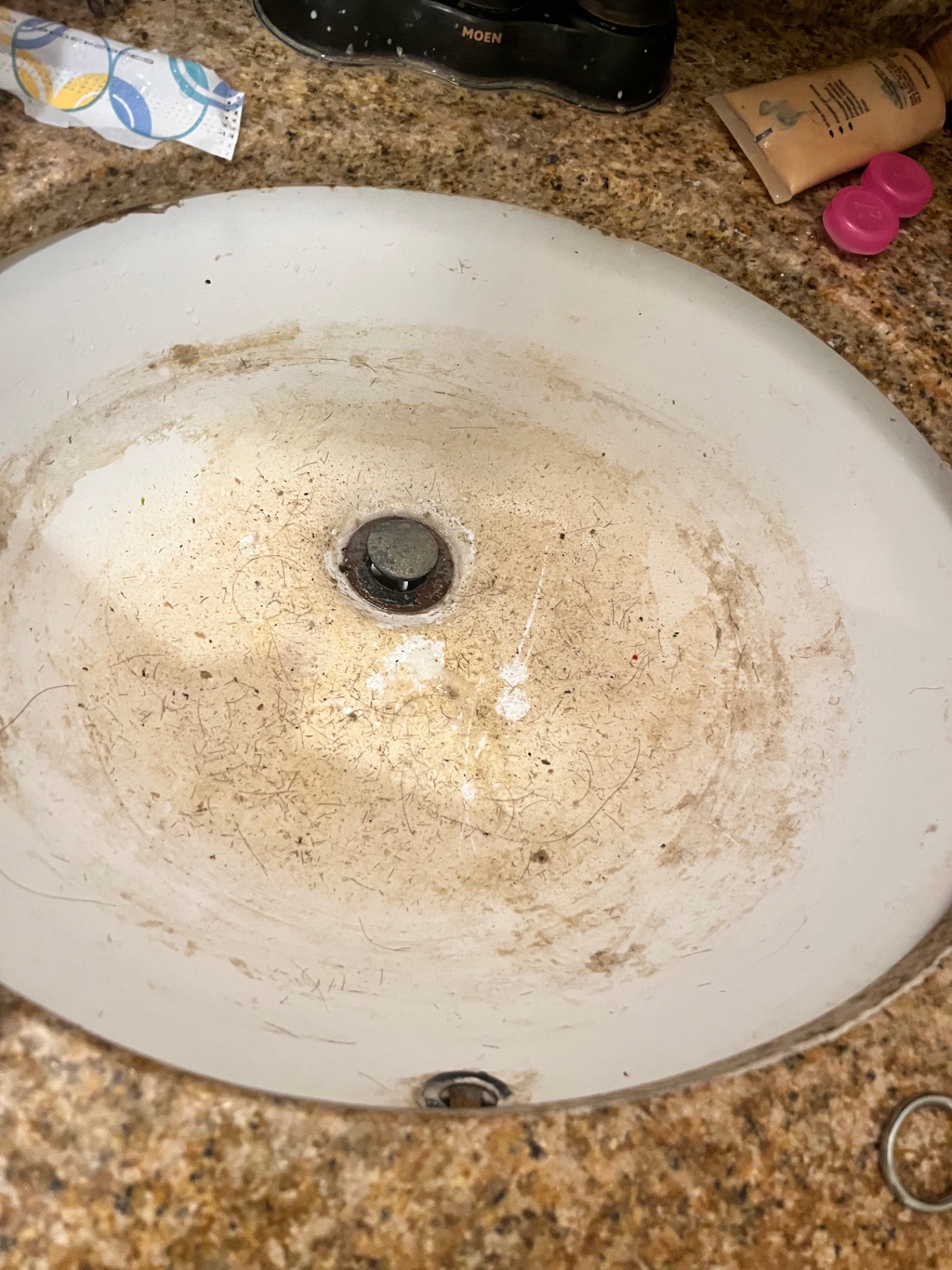 Bathroom sink basin covered in grime and hair before a Clean & Shine visit