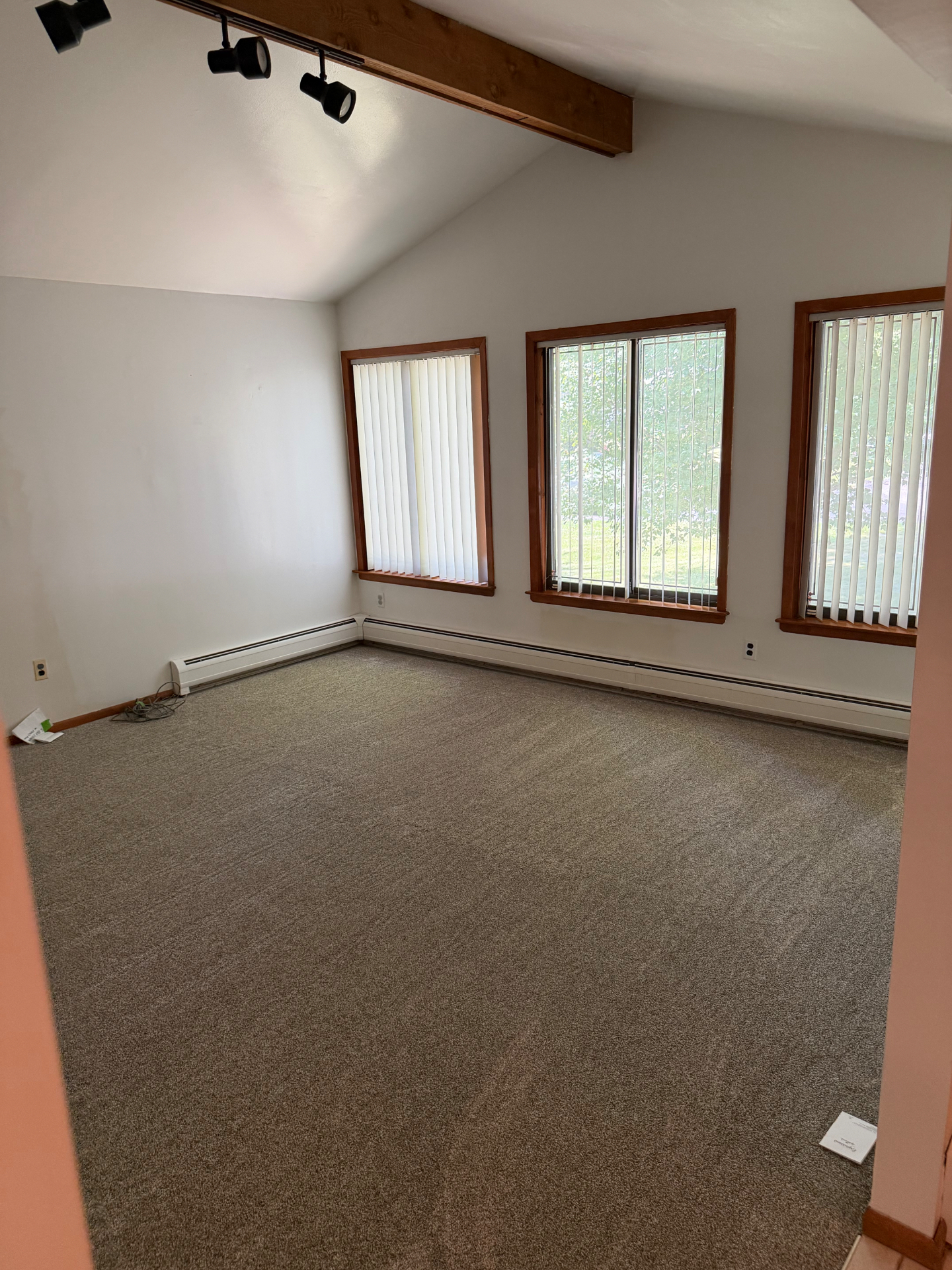 Bright bedroom with freshly cleaned carpet and dusted blinds after a Clean & Shine visit