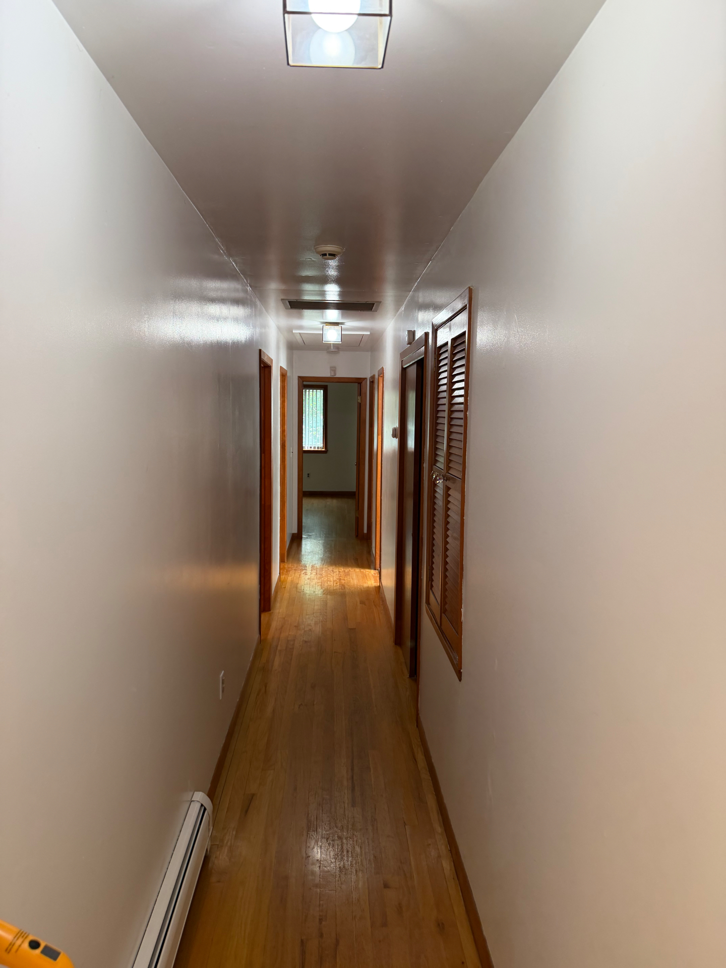 Clean hallway with shining hardwood floor and spotless walls after a Clean & Shine visit