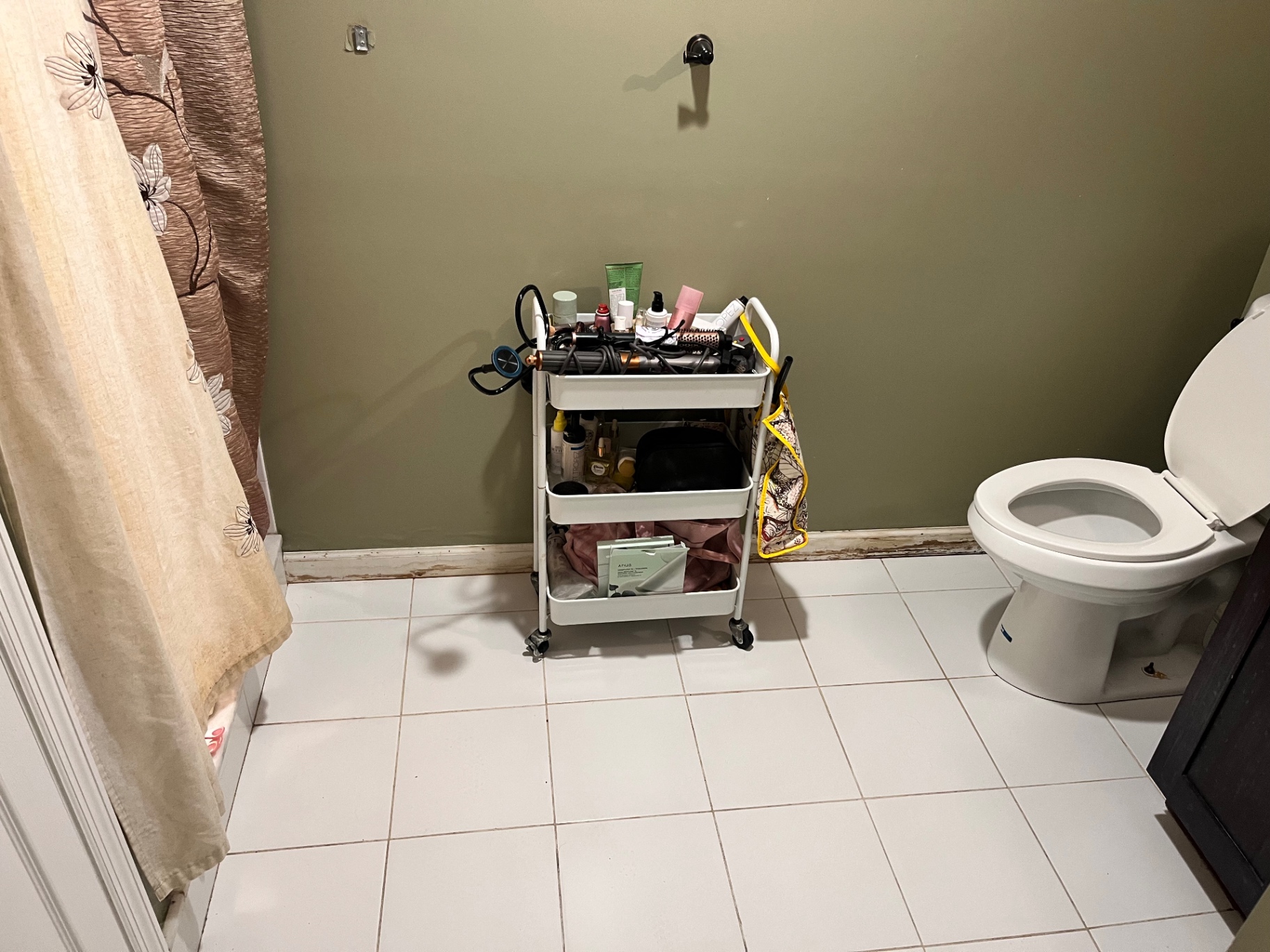 Tidy, organized bathroom with clean tile floor after a Clean & Shine visit