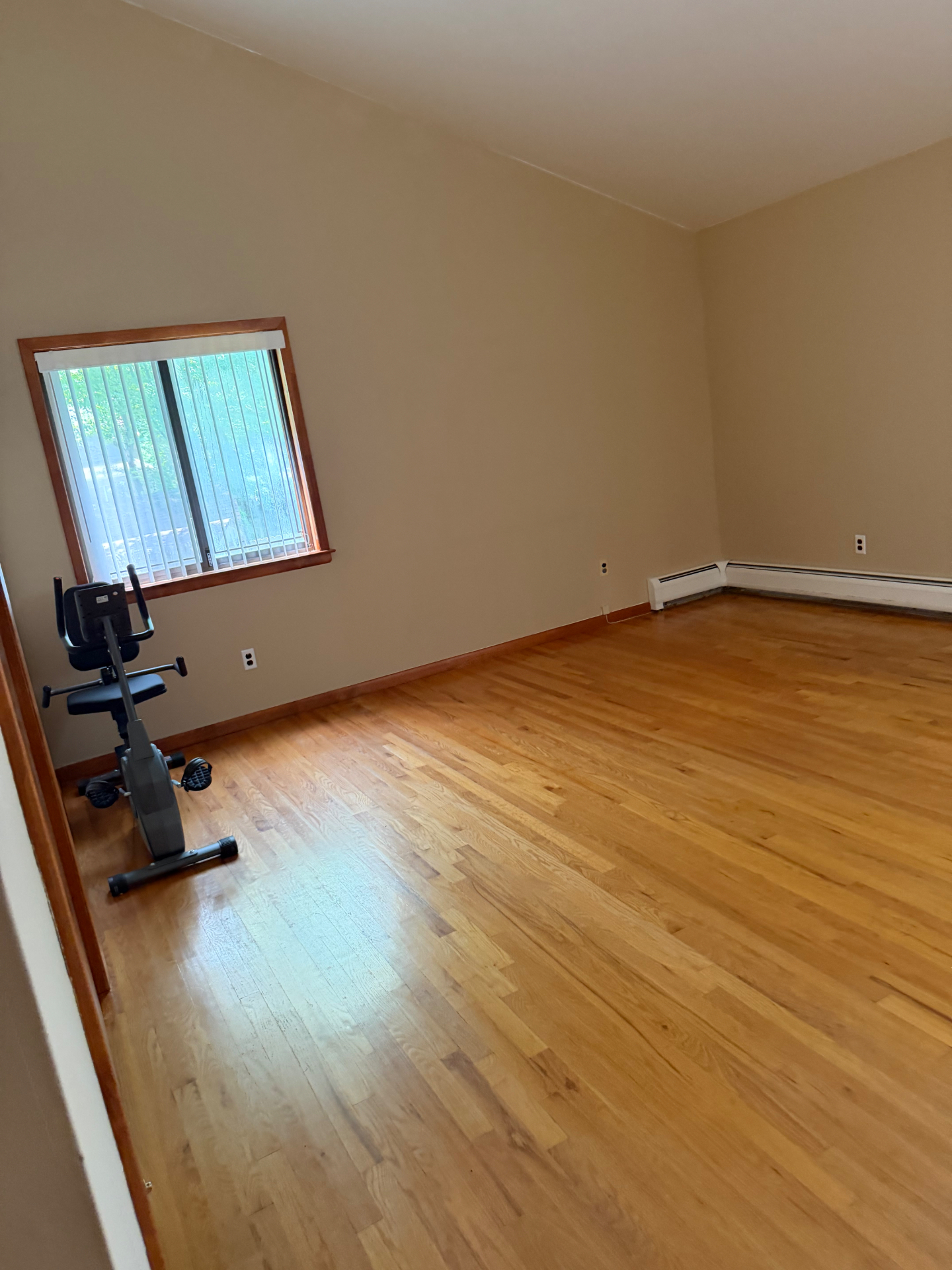 Spacious room with gleaming hardwood floors after a Clean & Shine move-out clean